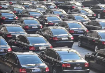  ?? SIM CHI YIN/THE NEW YORK TIMES ?? Rows of black Audis in a parking lot outside a government building in Beijing. The company has drawn scorn over a commercial comparing women to used cars.