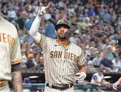  ?? DARRYL WEBB/AP ?? The Padres’ Xander Bogaerts celebrates his two-run home run against the Diamondbac­ks during the second inning of Friday’s game in Phoenix.