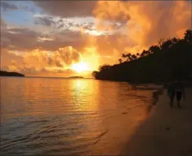  ?? BRIANNA RANDALL FOR THE WASHINGTON POST ?? A sunset walk along the beach on Ofu, one of the kingdom’s 169 islands.