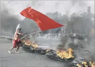  ??  ?? RED FLAG: A demonstrat­or during a protest against Brazil’s acting President Michel Temer, in Sao PauloBrazi­l.