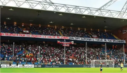  ??  ?? Genoa fans display a banner reading "In silence for you, hurt 43 times in the heart. Get back on your feet proudly and become splendid again!"