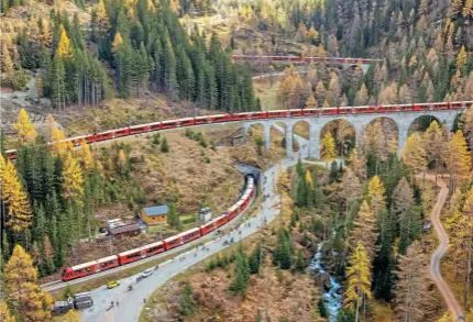  ?? PHILIPP SCHMIDLI/RHB ?? Never has the word ‘snaking’ been better applied to a passenger train, as the Rhaetian Railway’s record-breaking 100-car EMU descended from Preda to Bergün on October 29.