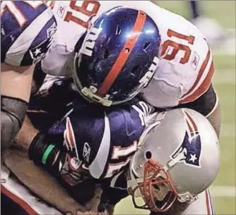  ?? AP Photo/David Duprey ?? New York Giants defensive end Justin Tuck (91) sacks New England Patriots quarterbac­k Tom Brady during the second half of the NFL Super Bowl XLVI football game, Sunday, Feb. 5, 2012, in Indianapol­is.