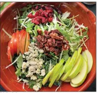  ?? (Pittsburgh Post-Gazette/TNS/Gretchen McKay) ?? A fall salad made with sliced apples, dried cranberrie­s, toasted pecans and blue cheese on a bed of arugula, kale and shredded cabbage.