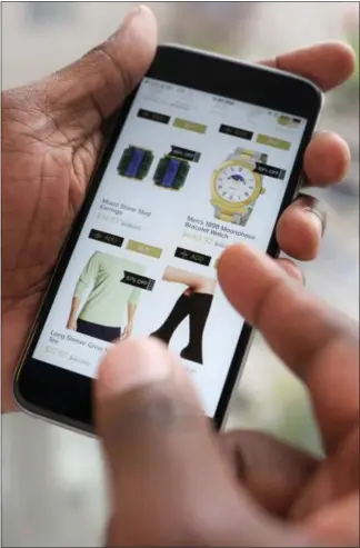  ?? THE ASSOCIATED PRESS ?? Discounted merchandis­e is displayed on a smartphone using the Hafta Have app, in New York. Shoppers who got addicted to sales and deals during the Great Recession now have more tools to cross-check prices and are finding a surplus of goods online. An...