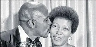  ?? AP FILE PHOTO ?? Louis Gossett Jr. kisses his co-star, Olivia Cole, as she holds one of the nine Emmys awarded to the cast and crew of the TV drama “Roots” at the Academy of Television, Arts and Sciences awards show in Los Angeles, Calif., in September 1977.