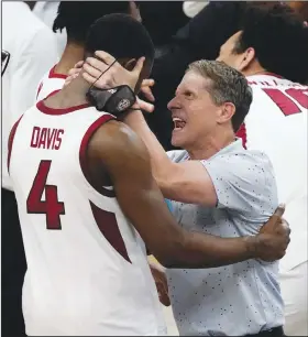  ?? Associated Press ?? New deal for Musselman: Arkansas head coach Eric Musselman, right, celebrates with guard Davonte Davis (4) after a Sweet 16 game against Oral Roberts in the NCAA men's college basketball tournament last month at Bankers Life Fieldhouse in Indianapol­is.