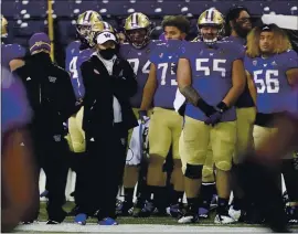  ?? TED S. WARREN — THE ASSOCIATED PRESS ?? Washington coach Jimmy Lake, center left, pulled out of the Pac-12 title game with USC on Friday due to COVID-19 issues.