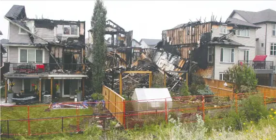  ?? BRENDAN MILLER ?? Four homes were damaged in a blaze in the 100 block of Sherwood Crescent N.W. early on Sunday morning. Three homes suffered significan­t damage.