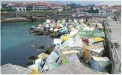  ??  ?? Coloured cubes protecting breakwater