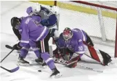  ?? ?? Warriors goaltender Jackson Unger keeps a close eye on the puck during a goalmouth scrum.