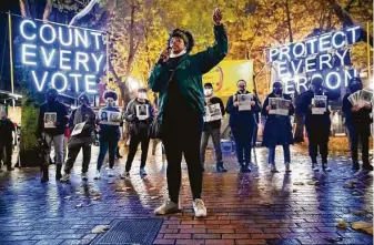  ?? Erika Schultz / Associated Press ?? Travonna Thompson-Wiley speaks for the Black Action Coalition, which demands that every vote is counted and an orderly transition of power, as well as the eliminatio­n of the Electoral College.