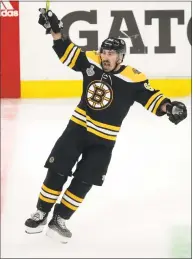  ?? Charles Krupa / Associated Press ?? The Bruins’ Brad Marchand, right, celebrates his emptynet goal during the third period in Game 1 of the Stanley Cup Finals against the Blues on Monday in Boston.