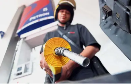  ??  ?? In full flow: Pakatan government’s latest move is to maintain prices of petrol and diesel at current rates.