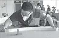  ?? GAO ERQIANG / CHINA DAILY ?? Zhang Jiahao, a 17-year-old carpenter, competes in the joinery event at the 2017 China Internatio­nal Skills Competitio­n.