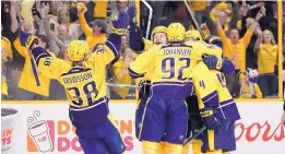  ?? MARK HUMPHREY/ASSOCIATED PRESS ?? Nashville Predators players celebrate after Roman Josi’s second-period goal against the Chicago Blackhawks. Nashville went on to a 4-1 victory.