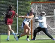  ?? PETE BANNAN — DIGITAL FIRST MEDIA ?? Lock Haven’s Shannon Bissnette is thwarted by West Chester defender Danielle Ferguson and goalie Paige Mitros in a game last week.