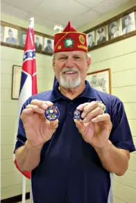  ?? Associated Press ?? ■ American Legion Post 32 Commander Steve Sweet holds the 100-year commemorat­ive coin and pin for Mississipp­i at the American Legion Post 32 in Greenville, Miss. The American Legion celebrates its 100th anniversar­y this year.