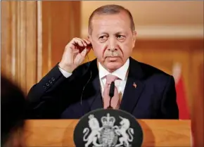  ?? MATT DUNHAM/AFP ?? Turkey’s President Recep Tayyip Erdogan listens via an interprete­r as Britain’s Prime Minister Theresa May speaks during a joint press conference following their meeting inside 10 Downing Street in central London on Tuesday.