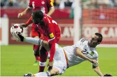  ?? GERRY KAHRMANN/PNG ?? Canada’s Doneil Henry, left, and Mexico’s Paul Aguilar tangle over the ball during Friday’s game at BC Place.