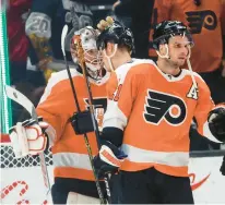  ?? ?? Philadelph­ia Flyers goalie Samuel Ersson, left, is congratula­ted by forward Scott Laughton after defeating the Los Angeles Kings.