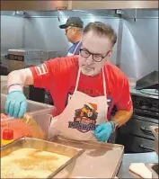  ?? Rick Vaughn Respect 90M ?? JOE MADDON, now the manager of the Angels, prepares food for the homeless during his time as manager of the Tampa Bay Rays, at a Metropolit­an Ministries event he calls “Thanksmas.”