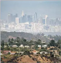  ??  ?? THE DOWNTOWN L.A. skyline comes into view at San Vicente Mountain Park, where sunsets are especially striking.