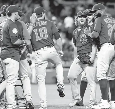  ?? MICHAEL OWENS/GETTY ?? Craig Kimbrel, middle right, celebrates with teammates after throwing a combined no-hitter Thursday.