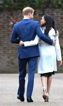  ??  ?? Prince Harry and Meghan Markle pose for the media after the official announceme­nt of their engagement. Meghan’s diamond ring was designed by Harry.