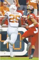  ?? PATRICK SEMANSKY/ASSOCIATED PRESS ?? Maryland wide receiver Jeshaun Jones looks back at Texas defensive back B.J. Foster as he runs for a touchdown in the first half of the Terps’ season-opening win.