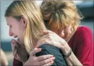  ?? STUART VILLANUEVA — THE GALVESTON COUNTY DAILY NEWS VIA AP ?? Santa Fe High School student Dakota Shrader is comforted by her mother Susan Davidson following a shooting at the school on Friday in Santa Fe, Texas. Shrader said her friend was shot in the incident.
