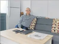  ??  ?? Art MacLeod sits in his recently constructe­d tiny house in Liverpool. He moved in Feb. 1.