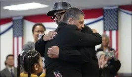  ?? GREGORY BULL — THE ASSOCIATED PRESS ?? Deported veterans Mauricio Hernandez Mata, center right, and Leonel Contreras embrace after being sworn in as U.S. citizens at a special naturaliza­tion ceremony Wednesday in San Diego.