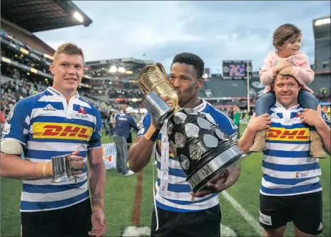  ?? Picture LEON LESTRADE, ANA ?? CUP KINGS: Sikhumbuzo Notshe kisses the golden Currie Cup as a happy Cobus Wise and JC Janse van Rensburg (and family) look on in Durban on Saturday.