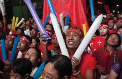  ?? KHIN MAUNG WIN/THE ASSOCIATED PRESS ?? Supporters of Burma opposition leader Aung San Suu Kyi’s National League for Democracy party cheer as they watch the results of the general election.