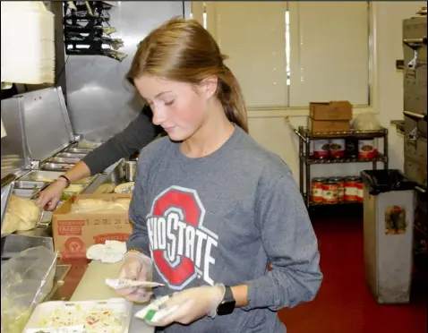  ??  ?? Drew Peachey, above, creates a salad at Lagrande's; at right is Stephanie Holtz, owner of Lucky Steer restaurant.