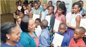  ?? BROWN/PHOTOGRAPH­ER RUDOLPH ?? Joydene Jarrett (second left), general manager of JPS &amp; Partners Co-operative Credit Union, and Kemesha Kelly (left), developmen­t consultant, chat with high school recipients of the company's scholarshi­p awards, which were presented during a luncheon at the Knutsford Court Hotel in St Andrew on Thursday.