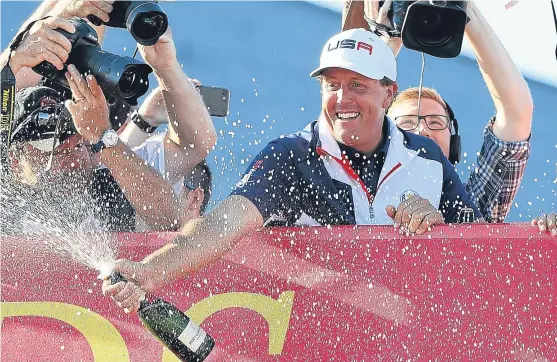  ?? Picture: Getty. ?? Phil Mickelson celebrates on the balcony after playing his part in bringing the trophy back into US hands.