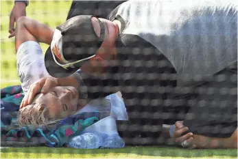  ?? DAVID RAMOS, GETTY IMAGES ?? Bethanie Mattek-Sands injured her knee in the opening game of the third set during her secondroun­d match Thursday. The American left the court on a stretcher and was taken to a hospital.