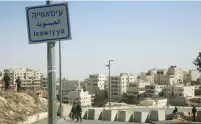  ?? (Marc Israel ?? POLICE PATROL at the entrance to the east Jerusalem neighborho­od of Isawiya.