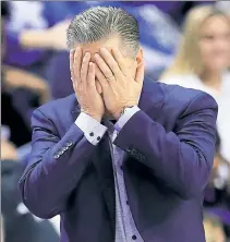  ?? Getty Images ?? CATS NOT RIGHT: Kentucky coach John Calipari buries his head in his hands during the first half of his No. 1 Wildcats’ home loss to Evansville on Tuesday night.