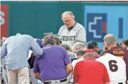  ??  ?? The Rev. Patrick J. Conroy, chaplain of the U.S. House of Representa­tives, prays as both teams kneel before the congressio­nal baseball game June 15, 2017, in Washington, D.C. The annual GOP-Democrats baseball game raises money for charity.