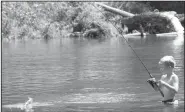  ?? Arkansas Democrat-Gazette/BRYAN HENDRICKS ?? Henry Hamm of Princeton, N.J., catches his first smallmouth bass Aug. 27 while wade fishing in the Caddo River.