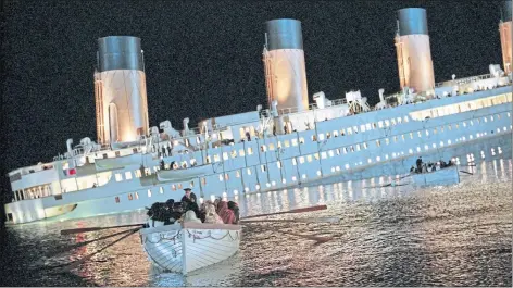  ?? ?? A lifeboat flees the sinking Titanic in director James Cameron’s epic 1997 blockbuste­r about the 1912 disaster