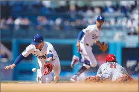  ?? Associated Press ?? Theft in progress: St. Louis Cardinals' Victor Scott II (11) steals second base against Los Angeles Dodgers' Gavin Lux (9) during the fifth inning of a baseball game Thursday in Los Angeles.