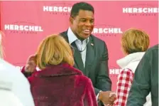  ?? AP PHOTO/JOHN BAZEMORE ?? Herschel Walker, Republican candidate for U.S. Senate in Georgia, greets supporters during a campaign rally Oct. 18 in Atlanta.