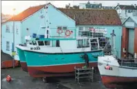  ?? OLI SCARFF / AFP ?? Above: A fisherman prepares his vessel at Bridlingto­n harbor in northeast England. London and Brussels recently reached agreement on fishing in UK waters, with a transition period of five and a half years.