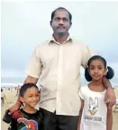  ??  ?? Glad they were spared: Dr. Aathavan with his children