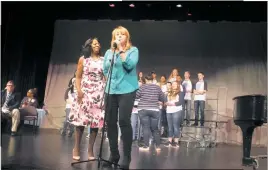  ??  ?? Lisa Shipley, La Plata High Class of 1982, center, performs “Love’s in Need” with the school’s Show Troupe and Chamber Choir for the Rev. Cynthia Warren Baker, the honoree of the class’s Unity Day celebratio­n Saturday.
