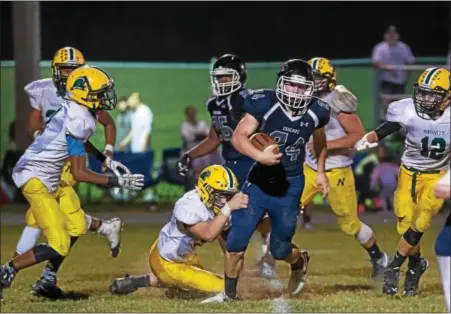  ?? SUBMITTED PHOTO - DENNIS KRUMANOCKE­R ?? The Nativity defense tries to bring down Logan Bachman during last Friday’s game.